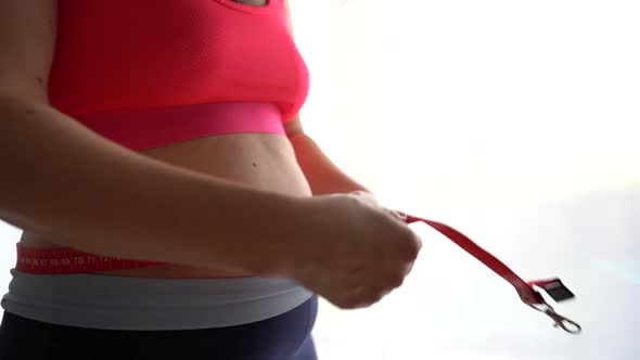 The Girl Measures the Circumference of the Waist with a Measuring Tape