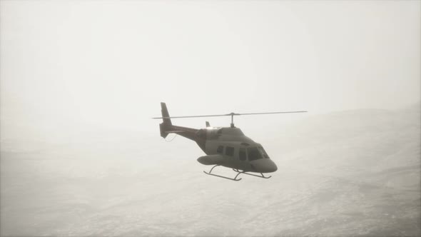 Extreme Slow Motion Flying Helicopter Near Mountains with Fog