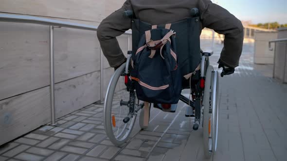 Equipped Area for Disabled People in City Wheelchairbound Man is Using Handicapped Ramp