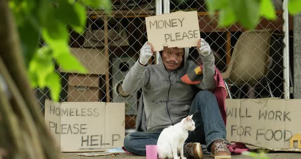 Homeless with dirty clothes holding money please label with cat