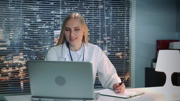 Female Doctor Making Online Video Call with Patient on Computer and Giving Recommendations