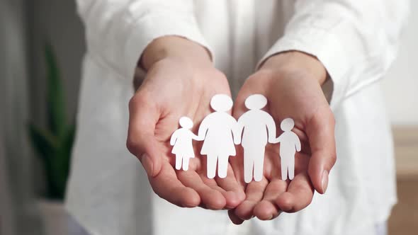 Women's Palm Hands Hold Paper People Family With Children, People Protection Insurance