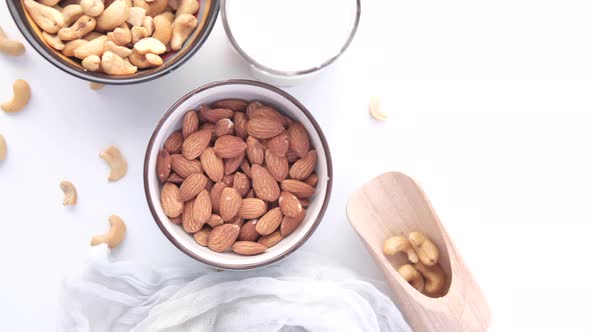 Fresh Almond Nut and Glass of Milk on Table