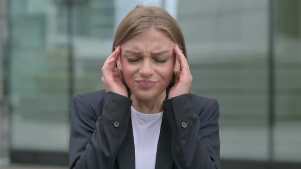 Portrait of Young Businesswoman Having Headache Outdoor