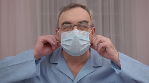 Close Up Portrait Elderly Man Takes Off a Medical Mask His Face