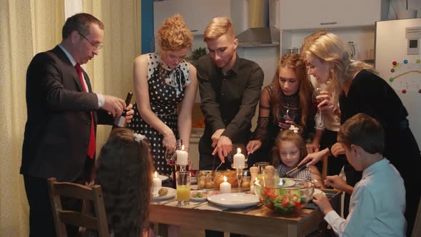 Group of People Have a Dinner, Put Food on Plates