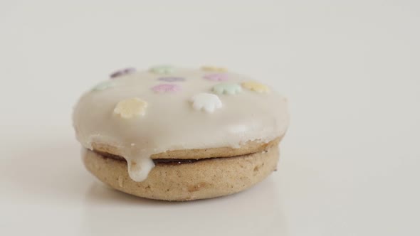 Tasty stuffed teacake close-up slow tilt 4K 2160p 30fps UltraHD footage - Sprinkles over the white c