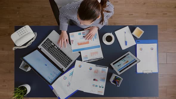 Top View of Businesswoman Sitting at Desk Table Checking Financial Accounting Documents