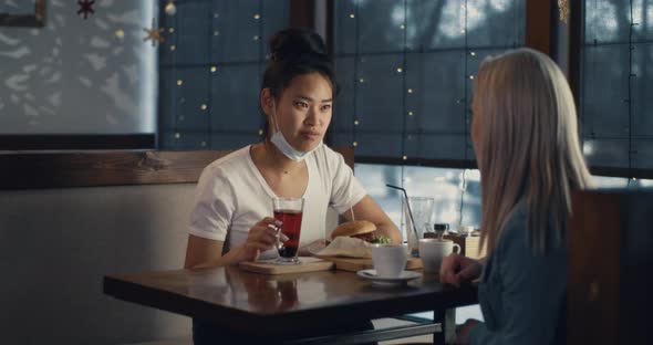 Multiracial Women Meeting in Cafe During COVID 19 Pandemic