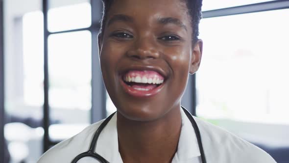 Portrait of african american female doctor looking at camera and smiling