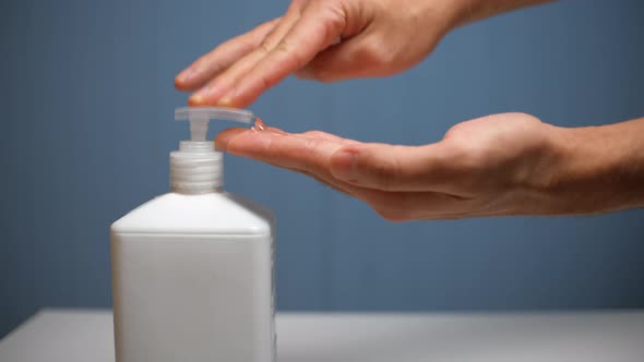 Man Showing Hand Hygiene Washing Hands with Hand Sanitizer