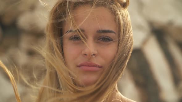 Close Up Portrait of Young Beautiful Woman with Amazing Blond Hair in the Wind