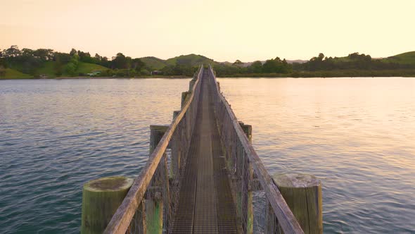 Wooden Bridge over Sea Bay in Summer Evening Sunset in New Zealand