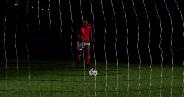 Soccer player scoring a goal against open goal post 4k