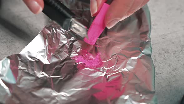 Hand made candles production, woman preparing a pink dye for wax