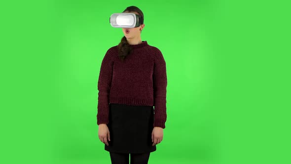 Happy Young Woman with Virtual Reality Headset or 3d Glasses. Green Screen