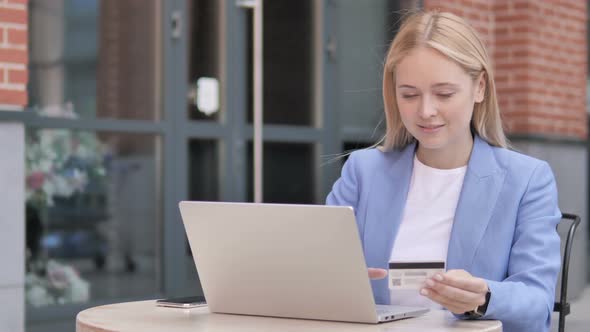 Online Shopping by Young Businesswoman Sitting Outdoor