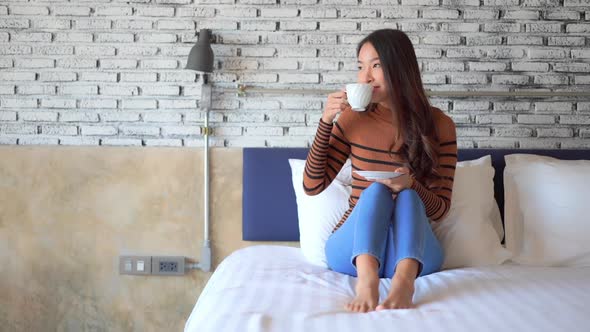 Young asian woman with coffee cup