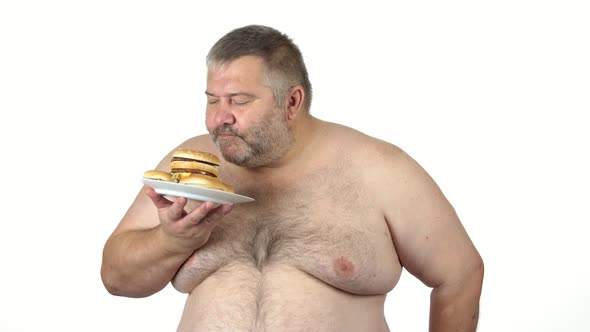 Fat Man Holding Plate with Burgers