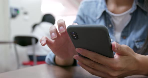 Woman touch on cellphone in restaurant