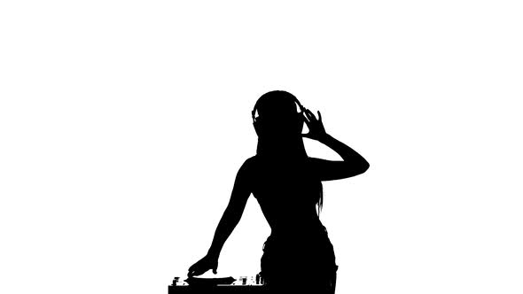 Girl Sexy DJ Turntable Rotates While Dancing. Slow Motion. Silhouette