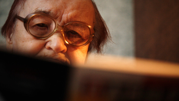 Old Woman In Glasses Reading A Book