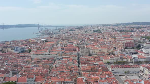 Ascending Wide Panoramic Aerial Reveal of Lisbon Cityscape with Densely Packed Traditional Colorful