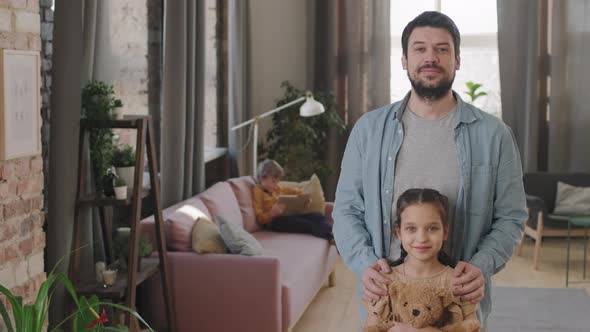 Portrait Of Smiling Dad And Little Daughter