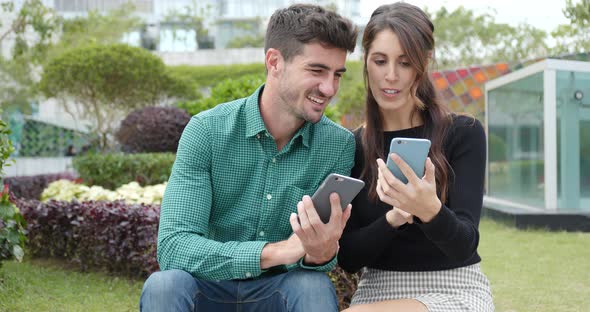 Couple using cellphone together at outdoor