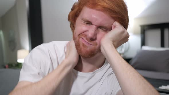 Tired Casually Sitting Redhead Man Close Up