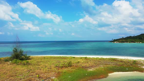 Aerial travel of marine shore beach adventure by transparent sea with white sandy background of a da