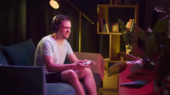 Young Man Gamer Playing Video Game on Tv Taking Off Headphones with Microphone Losing and Going Away