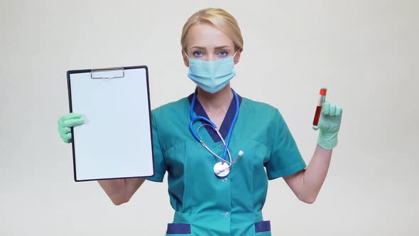 Medical Doctor Nurse Woman Wearing Protective Mask and - Holding Blood Test Tube and Plane Table