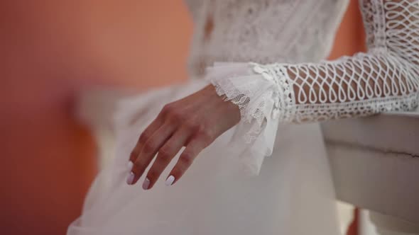 Woman in Old Fashioned Wedding Dress at Balcony Railing