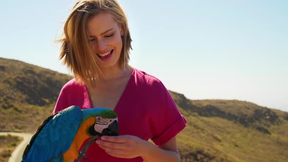 Parrot Nibbling Models Finger on a Sunny Day