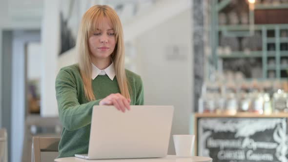 Young Woman Closing Laptop Standing Up Going Away in Cafe