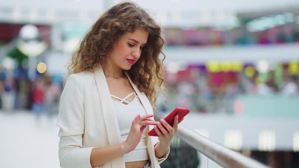 Woman Texting Message on Terrace of Shopping Mall