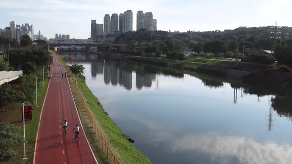 cyclists pedaling along Pinheiros river bike path in Sao Paulo, Brazil. high angle view