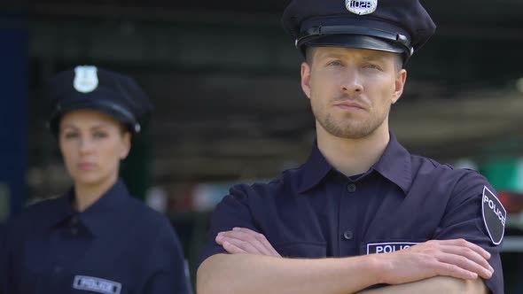 Young Professional Police Man and Woman Posing on Camera, Civil Policing Duties