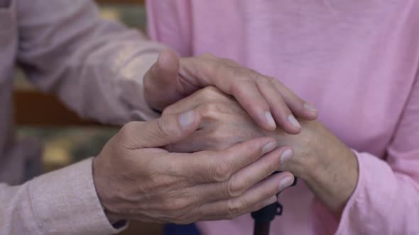 Aged Male Covering Female Hands Nursing Home Care Family Support Assistance