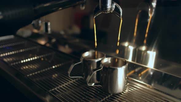 Coffee machine. Close-up - Pouring coffee into iron cups in coffee shop.