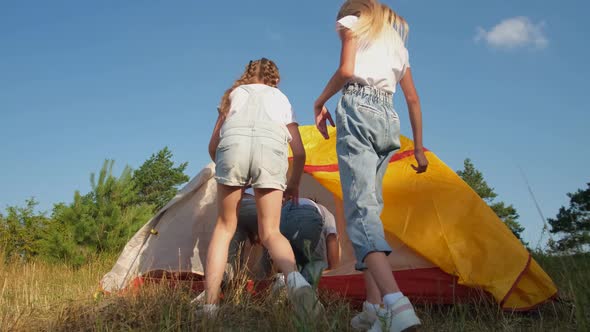 A Group of Children Enters a Yellow Tent a Children's Picnic