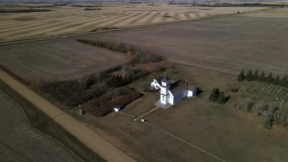 Drone footage of beautiful old heritage church sitting secluded in north American prairie landscape
