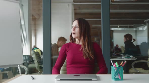 Turn your Own Dreams Into a Reality Young Businesswoman Sits at Table with a Laptop Working at