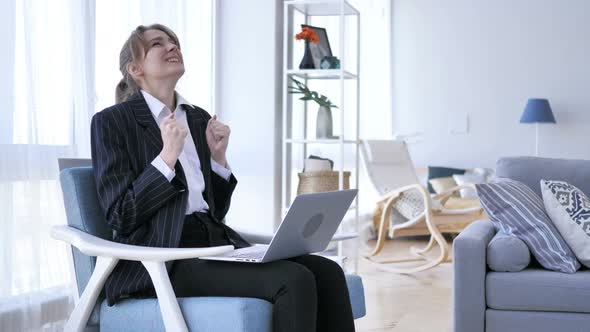 Excited Woman Celebrating Success, Working on Laptop