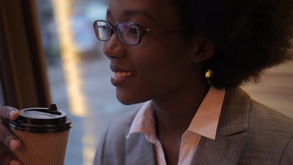 African Woman Working on Tablet at Cafe