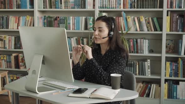 Young Woman Online Consultant with Headset Talking with Via Webcam