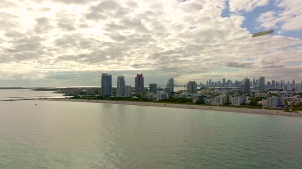 Aerial vast coastal landscape Miami Beach with cloudy sky