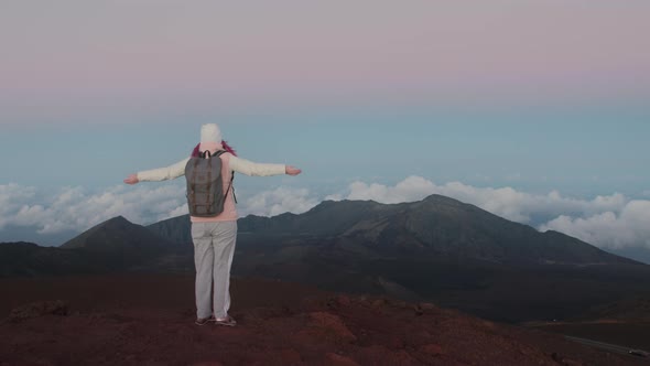 Slow Motion  Traveler Celebrating Climbing Top of Mountain and Raising Arms