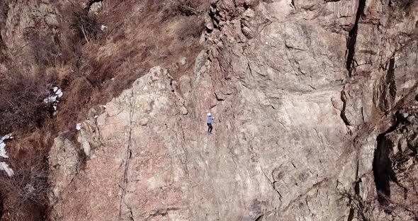 A Group of People are Engaged in Rock Climbing